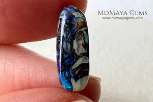 Koroit Boulder Opal 3.26 ct from Australia. Cabochon cut. Free form. I love the Koroit Opal with its intricate patterns, the precious opal embedded in the matrix fascinates me. In this case, the opal is the size of a pill with a very similar rounded shape,  and no matter which side you are looking at,  it is fascinating in any of them, its blue, red, green and lilac veins do not stop moving under the light. Just amazing.