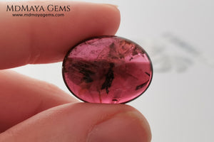 Large tourmaline rubellite, 16.08 ct, oval cabochon cut. This beautiful natural gem features two shades of color, one darker than the other. Although it has inclusions, it will be beautiful once mounted on any piece of jewelry you can imagine. And the best its price. $15 per carat.