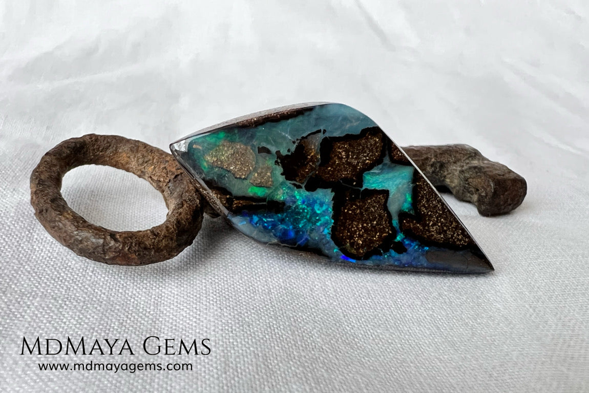 Stunning Boulder Opal 25.14 ct. from Australia. Cabochon Cut. Free Form. Imagine an island surrounded by deep blue-green waters, that's what this opal is.