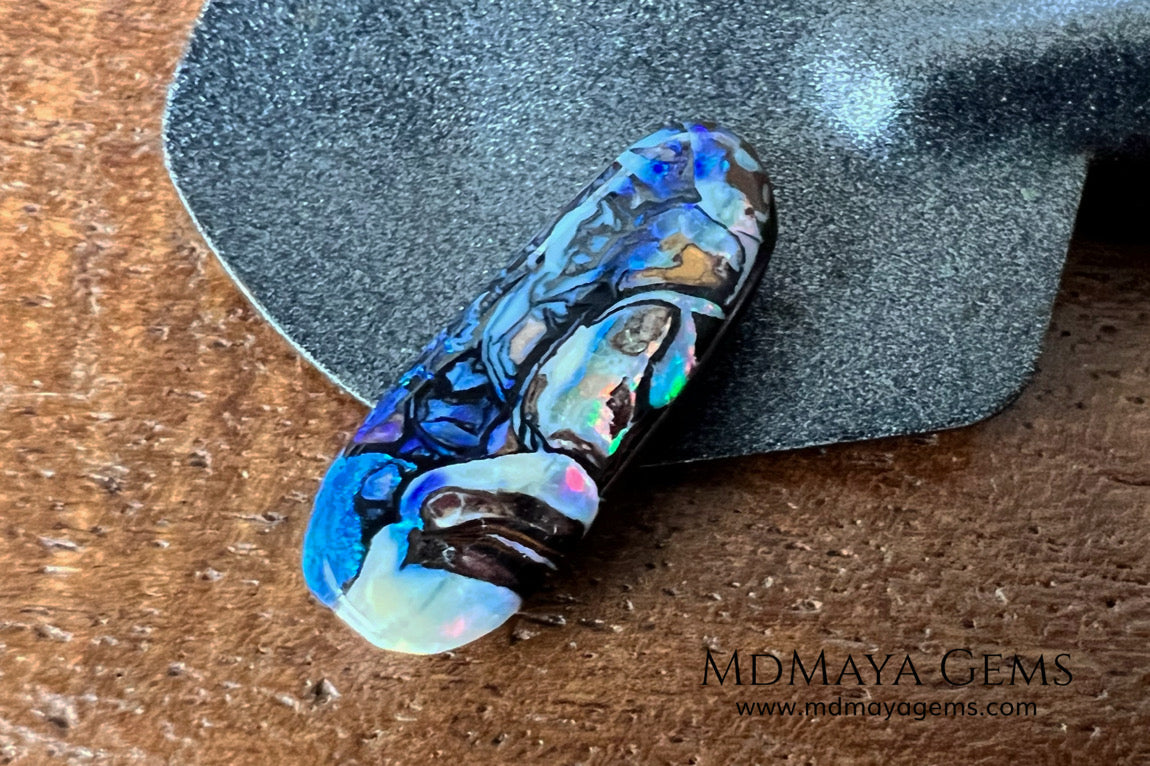 Koroit Boulder Opal 3.26 ct from Australia. Cabochon cut. Free form. I love the Koroit Opal with its intricate patterns, the precious opal embedded in the matrix fascinates me. In this case, the opal is the size of a pill with a very similar rounded shape,  and no matter which side you are looking at,  it is fascinating in any of them, its blue, red, green and lilac veins do not stop moving under the light. Just amazing.