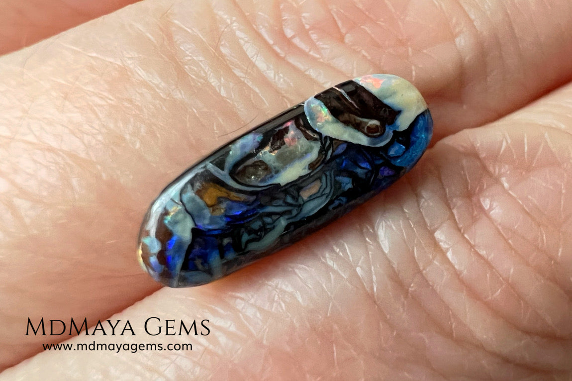 Koroit Boulder Opal 3.26 ct from Australia. Cabochon cut. Free form. I love the Koroit Opal with its intricate patterns, the precious opal embedded in the matrix fascinates me. In this case, the opal is the size of a pill with a very similar rounded shape,  and no matter which side you are looking at,  it is fascinating in any of them, its blue, red, green and lilac veins do not stop moving under the light. Just amazing.