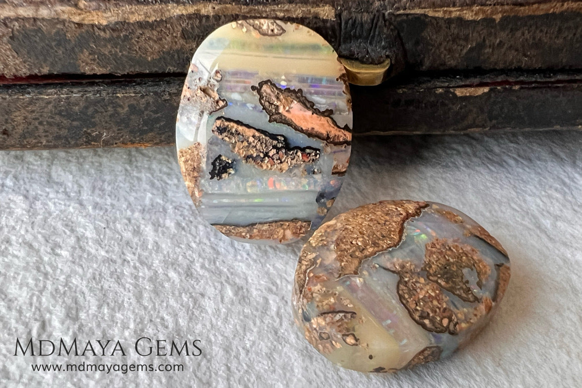 Boulder Wood Fossil Opal Pair from Australia Cabochon Cut 16.14 ct total.  This beautiful untreated pair has many qualities, for starters they are double sided, they show a beautiful pattern with their neon blue, green, red, purple, yellow and orange peeking out from all sides and are a very good size, not too big or very small, so they will be very comfortable and not too heavy earrings.