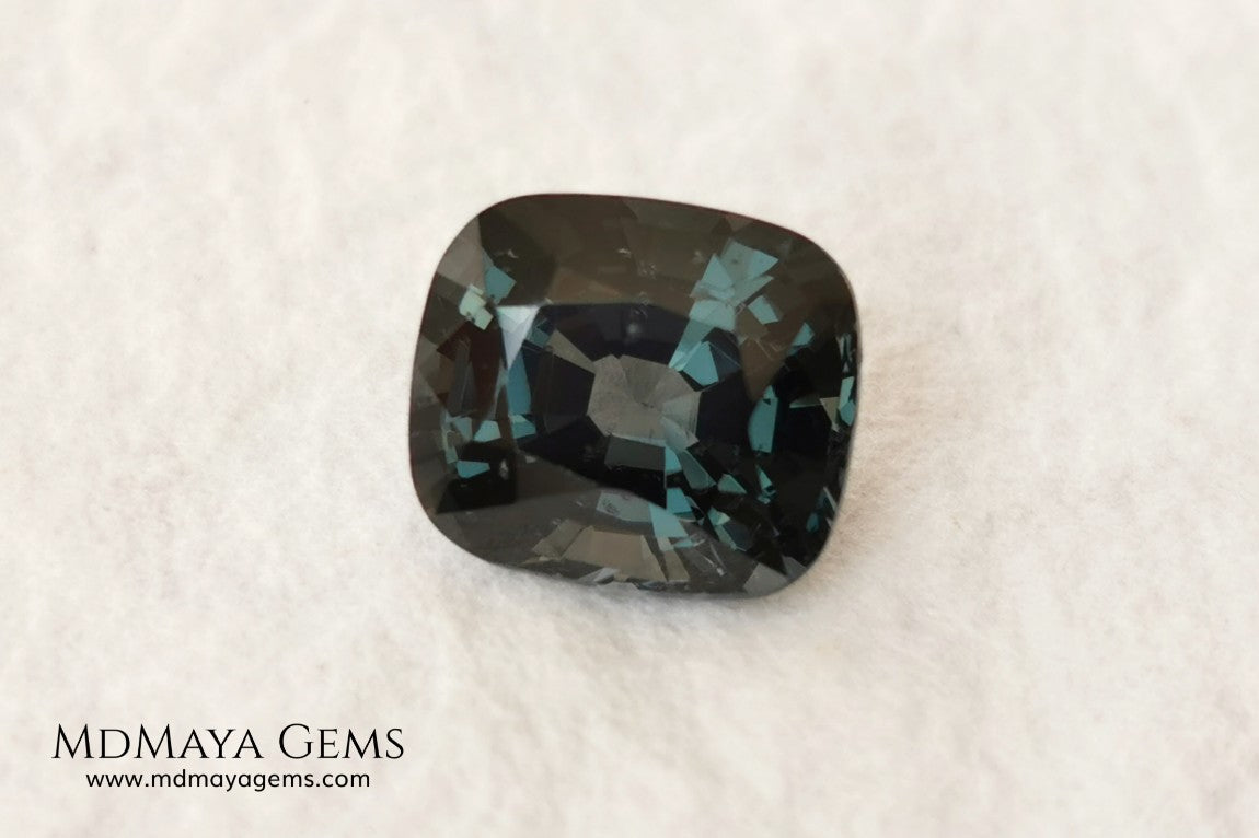 Gorgeous greenish gray spinel, 3.13 ct, cushion cut. This natural and untreated gemstone has an antique cut, its size is ideal, neither too big nor too small. Its behaviour under light is amazing, has a beautiful color under incandescent light, and contains a small treasure inside, another small spinel fully formed, a delight both outside and inside. Mother nature is perfect. It will be ideal in any jewel that you want to personalize. Spinels are gems with rising value.