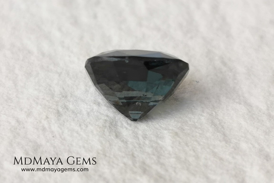 Gorgeous greenish gray spinel, 3.13 ct, cushion cut. This natural and untreated gemstone has an antique cut, its size is ideal, neither too big nor too small. Its behaviour under light is amazing, has a beautiful color under incandescent light, and contains a small treasure inside, another small spinel fully formed, a delight both outside and inside. Mother nature is perfect. It will be ideal in any jewel that you want to personalize. Spinels are gems with rising value.