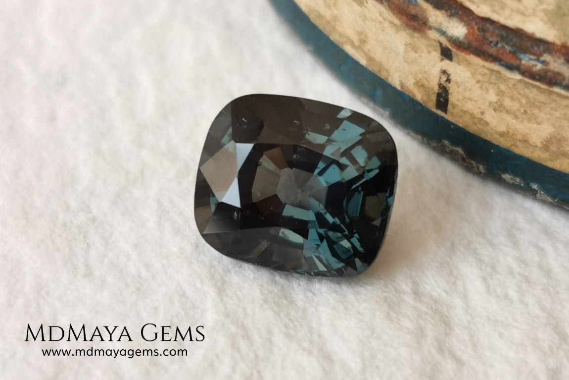 Gorgeous greenish gray spinel, 3.13 ct, cushion cut. This natural and untreated gemstone has an antique cut, its size is ideal, neither too big nor too small. Its behaviour under light is amazing, has a beautiful color under incandescent light, and contains a small treasure inside, another small spinel fully formed, a delight both outside and inside. Mother nature is perfect. It will be ideal in any jewel that you want to personalize. Spinels are gems with rising value.