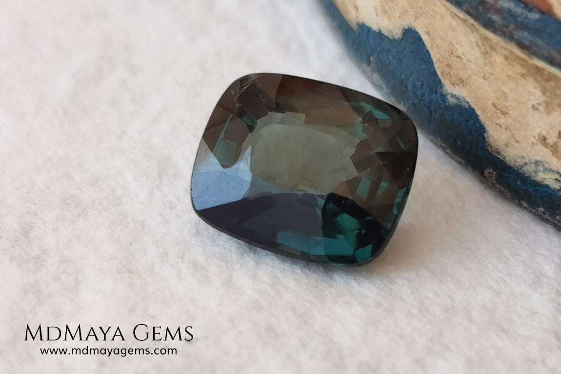 Rare Blue Green Spinel 1.86 ct, cushion cut. This natural and untreated gemstone has an antique cut, its green color is very rare, its size is ideal, neither too big nor too small. Its behavior under light is amazing, has a beautiful and bright color under day light and more green under incandescent light. It will look perfect in your custom jewelry. Spinels are gems with rising value.