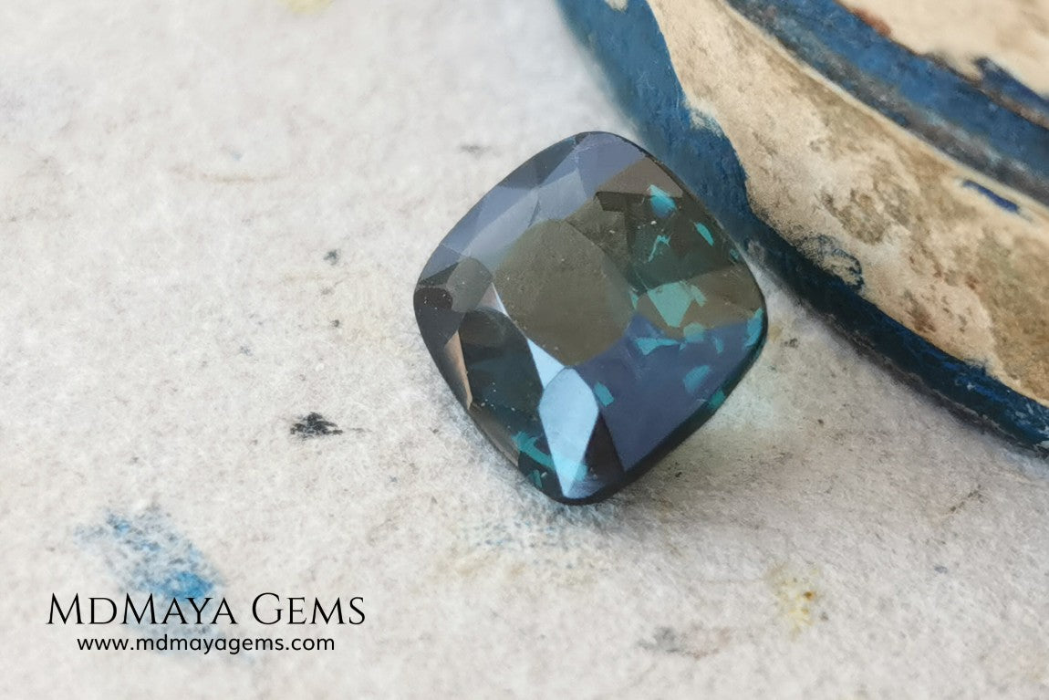 Rare Blue Green Spinel 1.86 ct, cushion cut. This natural and untreated gemstone has an antique cut, its green color is very rare, its size is ideal, neither too big nor too small. Its behavior under light is amazing, has a beautiful and bright color under day light and more green under incandescent light. It will look perfect in your custom jewelry. Spinels are gems with rising value.