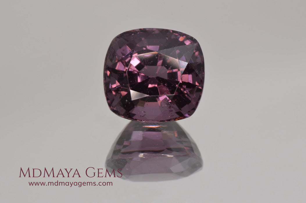 Large dark grayish reddish purple Spinel 5.30 ct under incandescent light