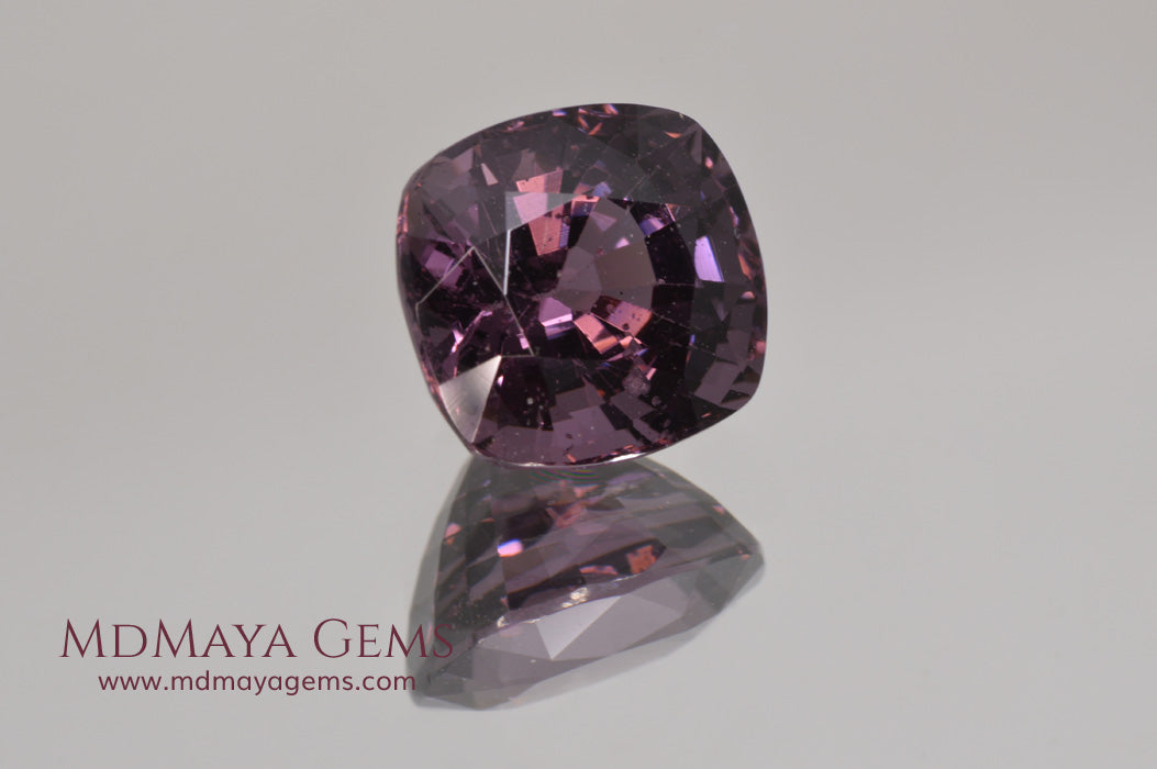 Large dark grayish reddish purple Spinel 5.30 ct under incandescent light