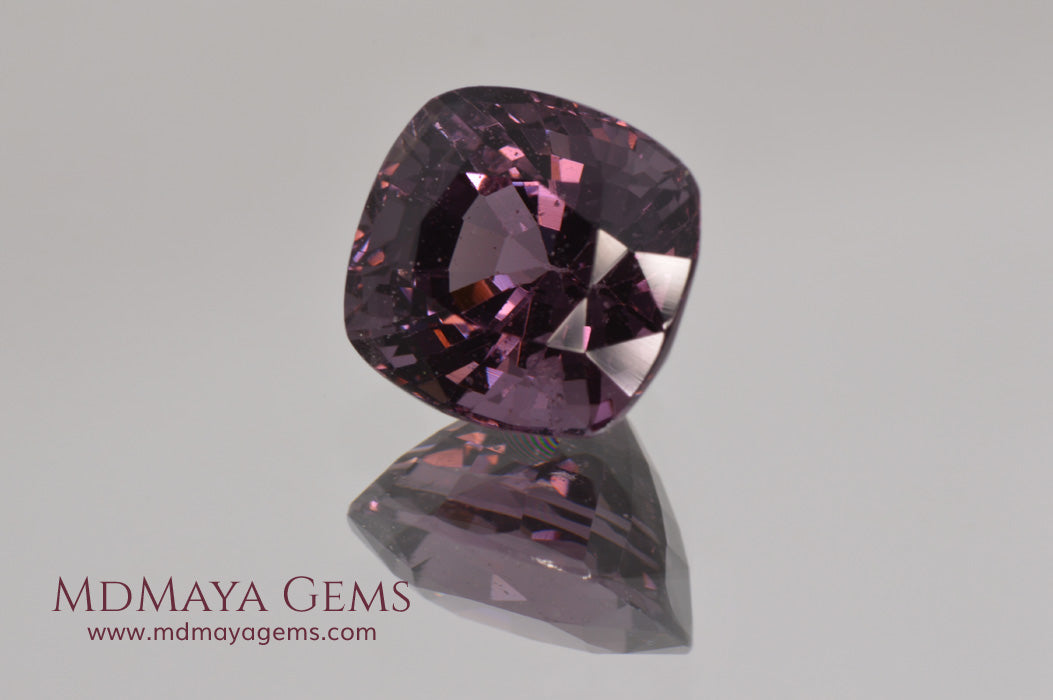 Large dark grayish reddish purple Spinel 5.30 ct under incandescent light