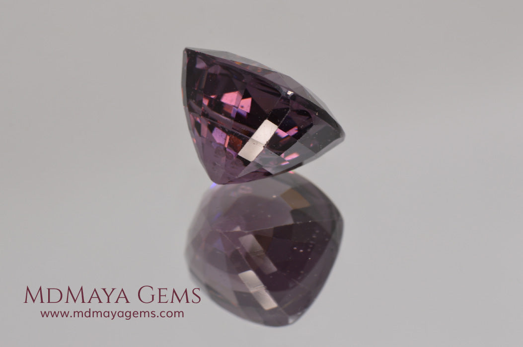 Large dark grayish reddish purple Spinel 5.30 ct under incandescent light