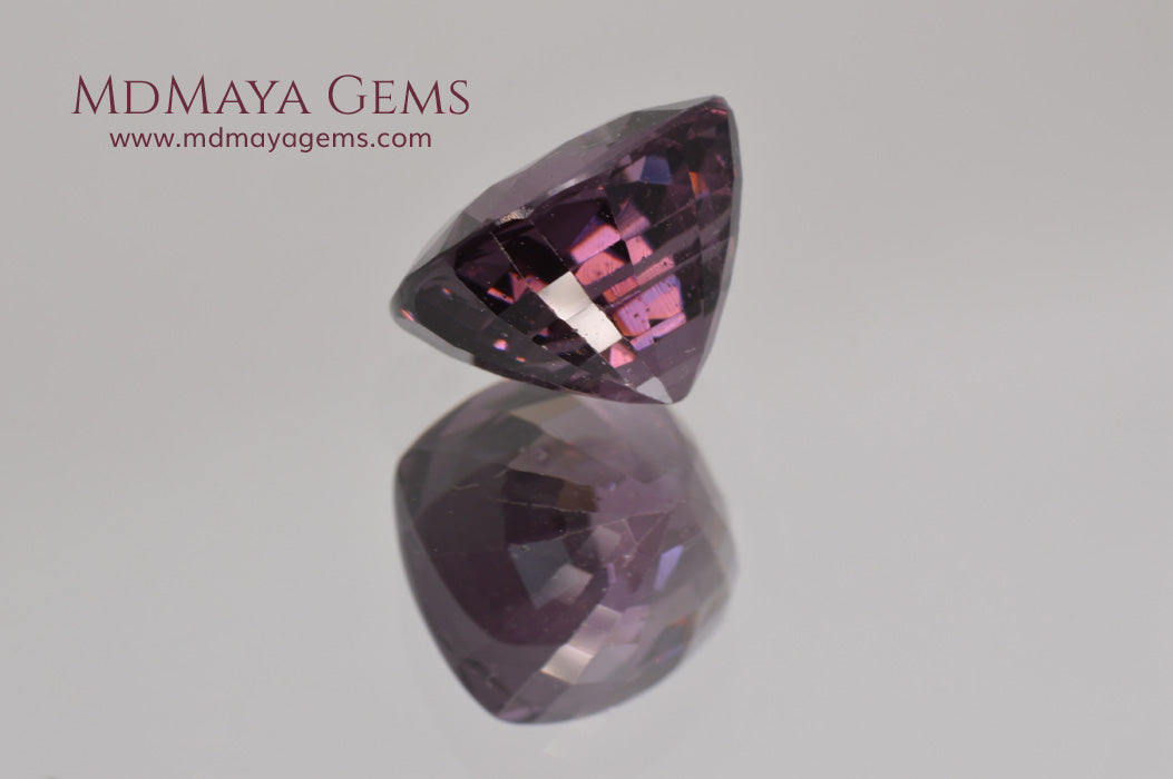 Large dark grayish reddish purple Spinel 5.30 ct under incandescent light