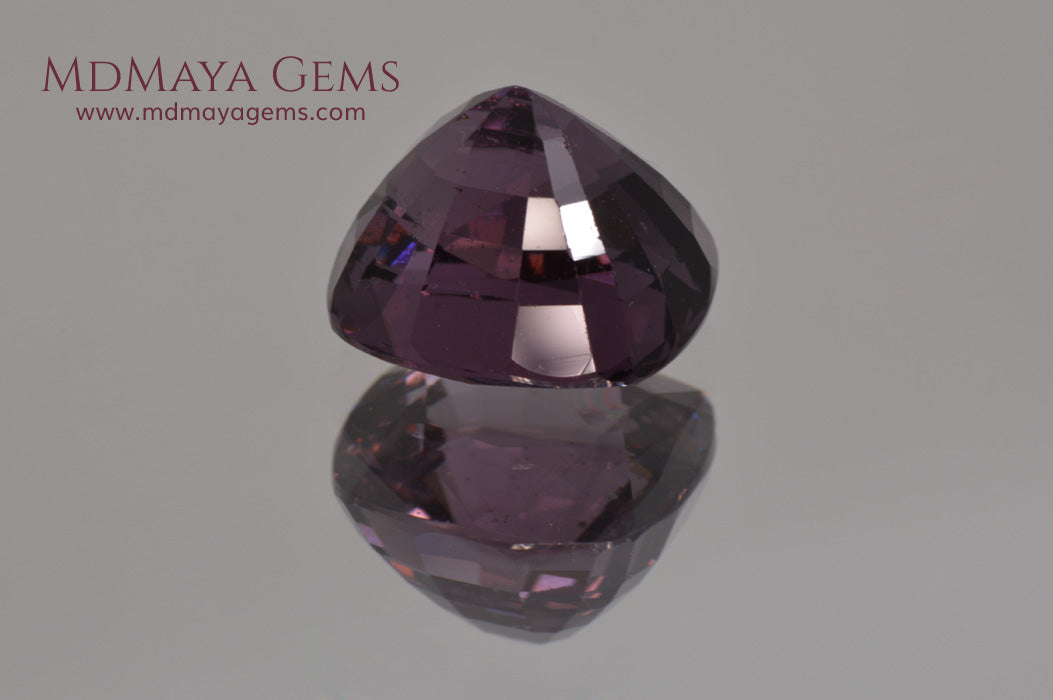 Large dark grayish reddish purple Spinel 5.30 ct under incandescent light
