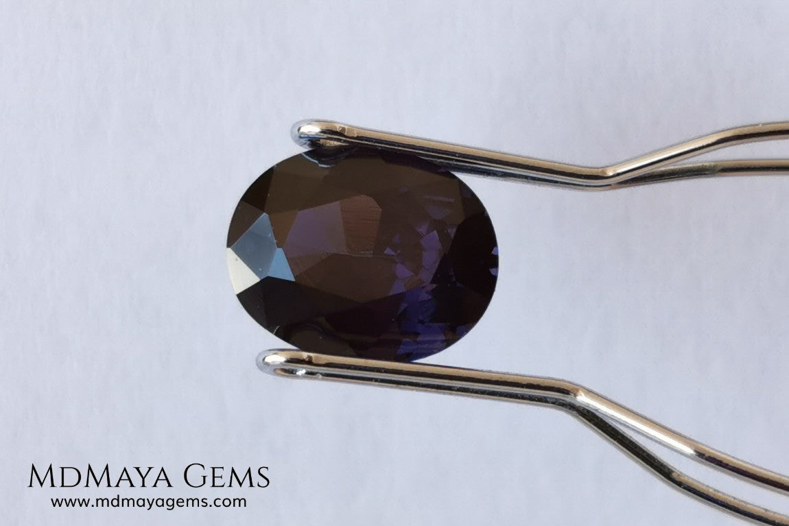 Dark Violet Spinel, 2.10 ct, oval cut. This dark gemstone has magnificent behavior under different light, under incandescent light, blue and purple sparkles are seen in it, making it very attractive. If you like different gems, you will like this one. Perfect for your custom jewelry.
