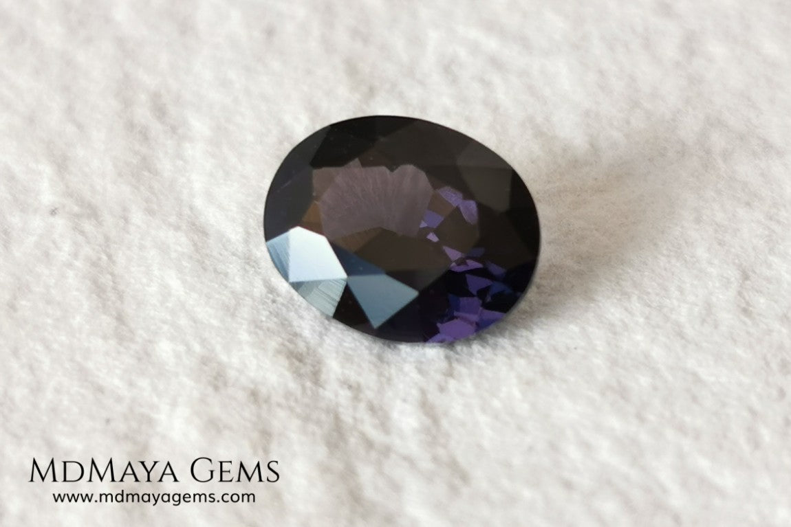 Dark Violet Spinel, 2.10 ct, oval cut. This dark gemstone has magnificent behavior under different light, under incandescent light, blue and purple sparkles are seen in it, making it very attractive. If you like different gems, you will like this one. Perfect for your custom jewelry.