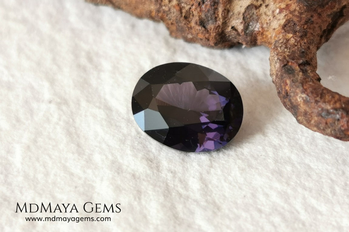 Dark Violet Spinel, 2.10 ct, oval cut. This dark gemstone has magnificent behavior under different light, under incandescent light, blue and purple sparkles are seen in it, making it very attractive. If you like different gems, you will like this one. Perfect for your custom jewelry.