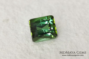 Bright Yellowish Green Tourmaline. 1.26 ct. Rectangular, scissor cut. This beautiful and natural green gemstone shows a vivid and bright color, its behavior under any kind of light is wonderful, always plenty of life and color. It will look perfect in a ring. Low price.