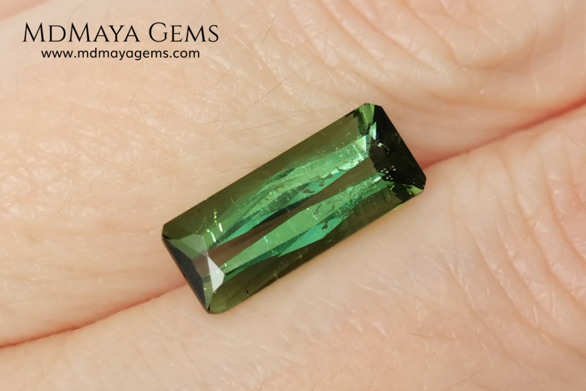 Green Tourmaline. 2.74 ct. Baguette cut. This elongated green stone shows a vivid and bright color. Its behavior under any type of light is marvelous, this pretty gem will look perfect in any kind of jewelry.