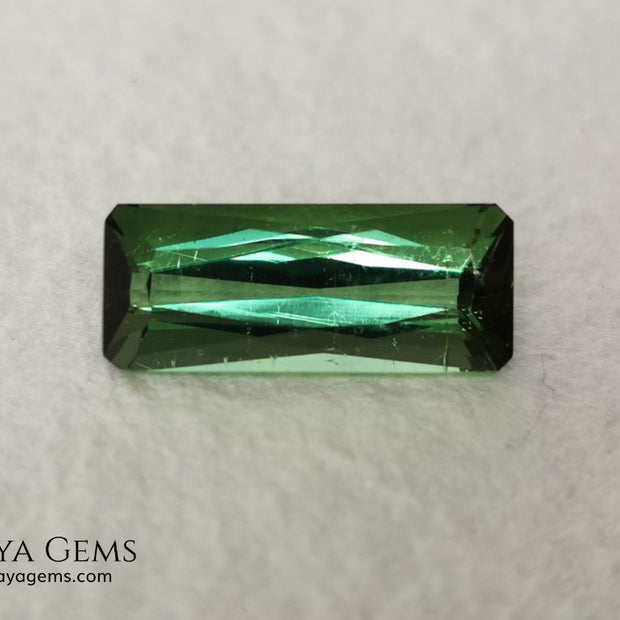 Green Tourmaline. 2.74 ct. Baguette cut. This elongated green stone shows a vivid and bright color. Its behavior under any type of light is marvelous, this pretty gem will look perfect in any kind of jewelry.