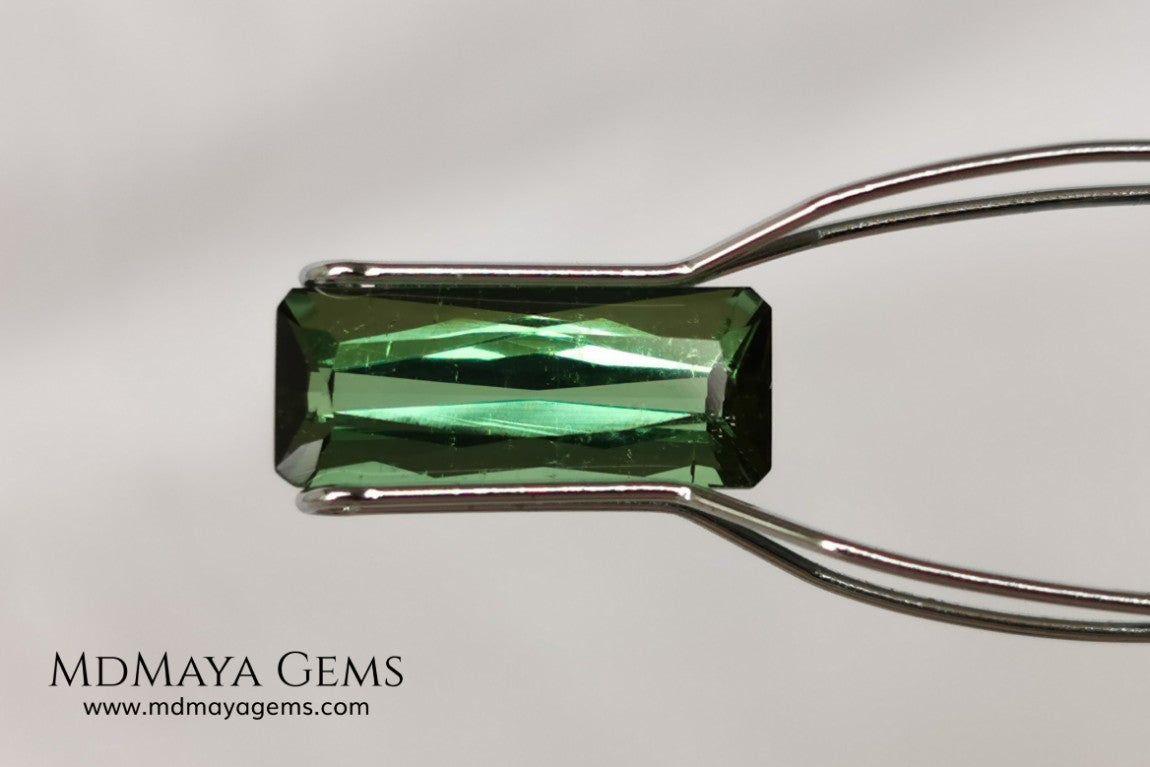 Green Tourmaline. 2.74 ct. Baguette cut. This elongated green stone shows a vivid and bright color. Its behavior under any type of light is marvelous, this pretty gem will look perfect in any kind of jewelry.