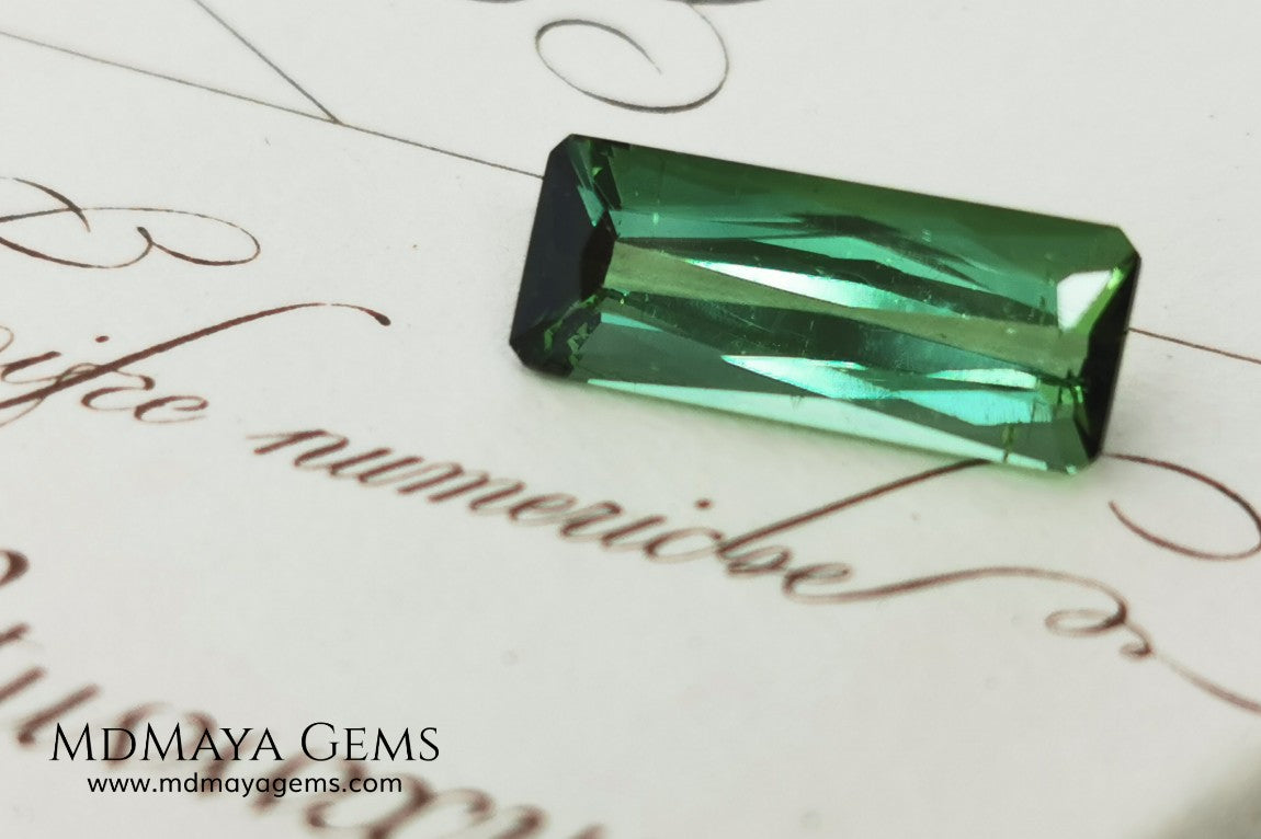 Green Tourmaline. 2.74 ct. Baguette cut. This elongated green stone shows a vivid and bright color. Its behavior under any type of light is marvelous, this pretty gem will look perfect in any kind of jewelry.