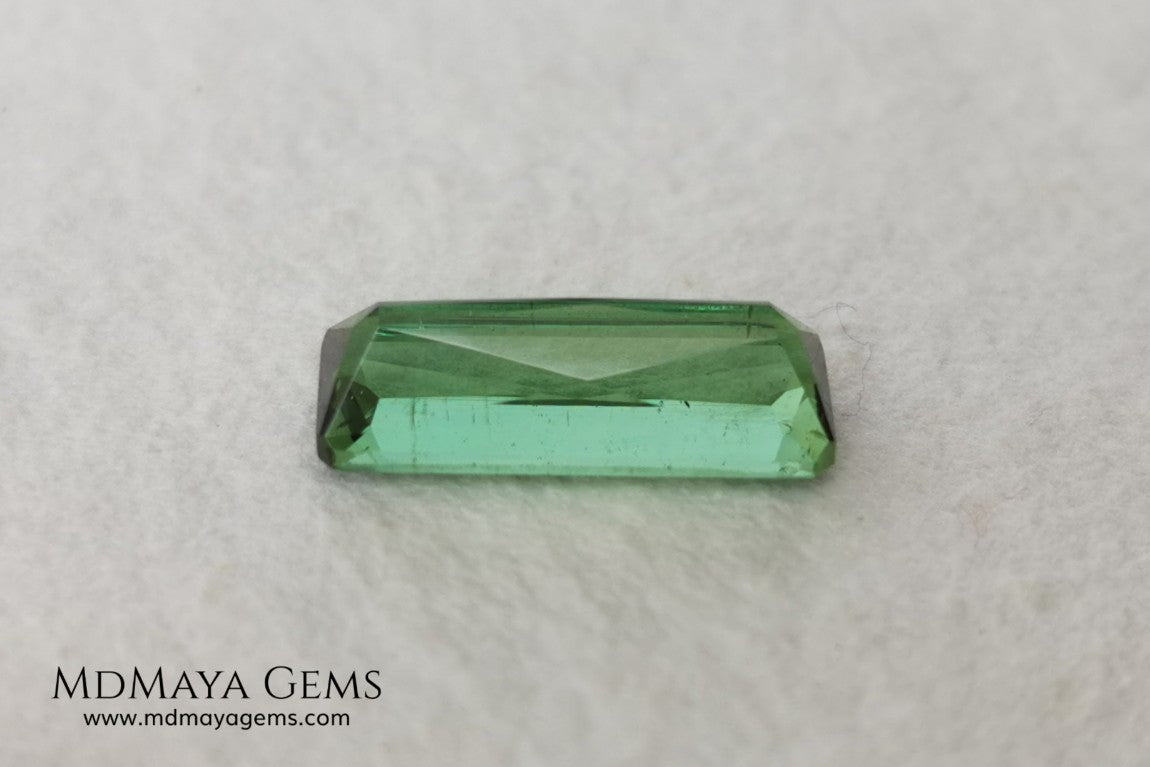 Green Tourmaline. 2.74 ct. Baguette cut. This elongated green stone shows a vivid and bright color. Its behavior under any type of light is marvelous, this pretty gem will look perfect in any kind of jewelry.