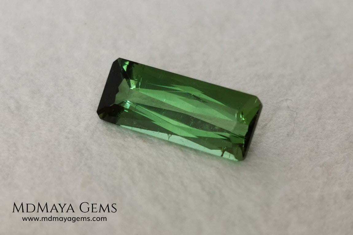 Green Tourmaline. 2.74 ct. Baguette cut. This elongated green stone shows a vivid and bright color. Its behavior under any type of light is marvelous, this pretty gem will look perfect in any kind of jewelry.