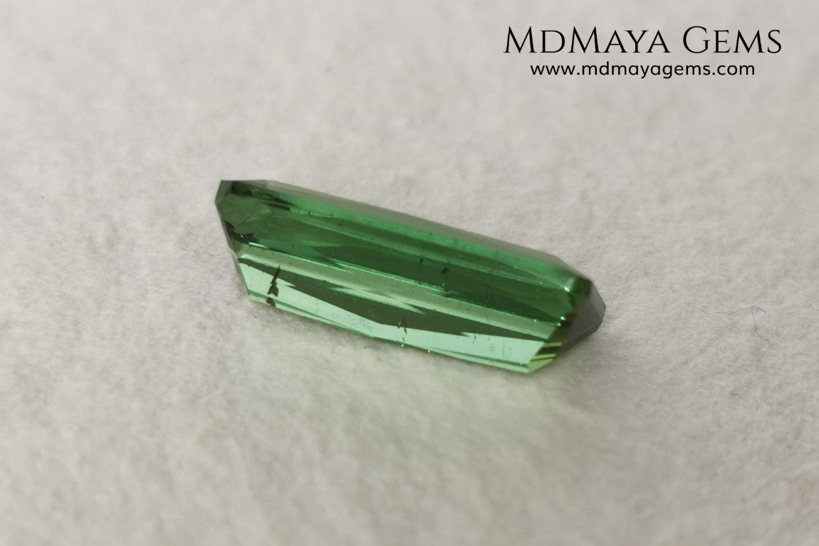 Green Tourmaline. 2.74 ct. Baguette cut. This elongated green stone shows a vivid and bright color. Its behavior under any type of light is marvelous, this pretty gem will look perfect in any kind of jewelry.