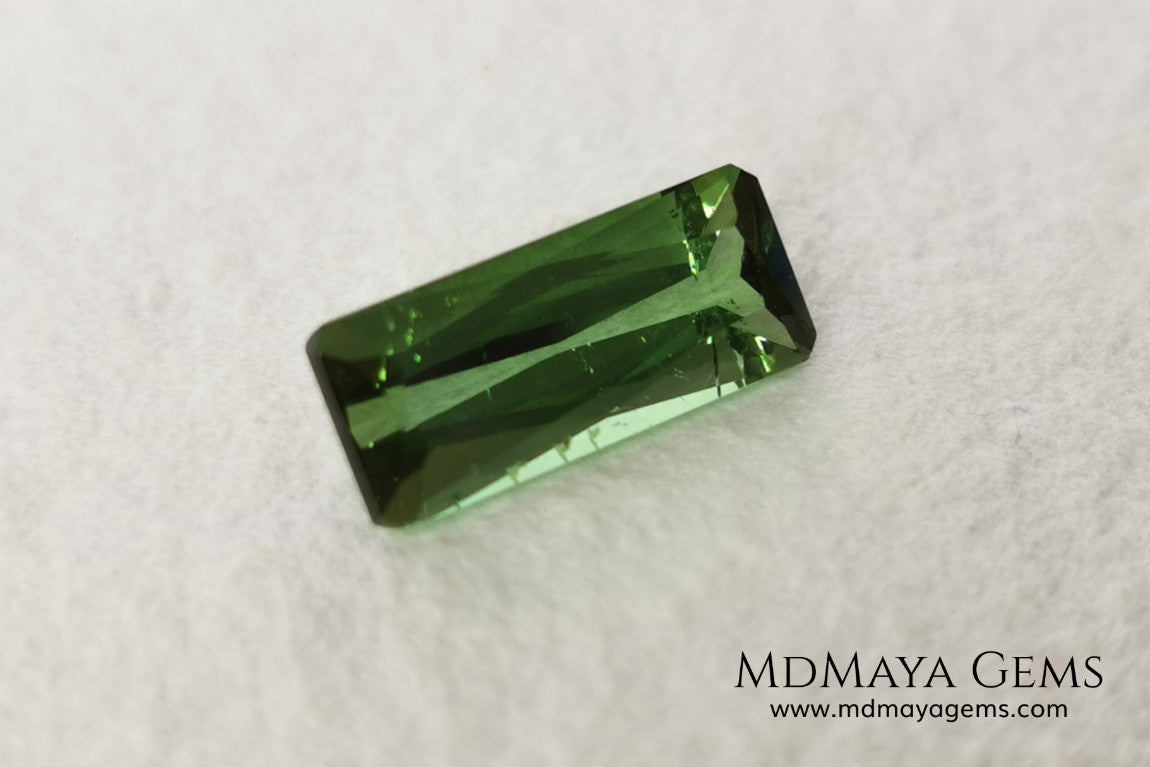 Green Tourmaline. 2.74 ct. Baguette cut. This elongated green stone shows a vivid and bright color. Its behavior under any type of light is marvelous, this pretty gem will look perfect in any kind of jewelry.
