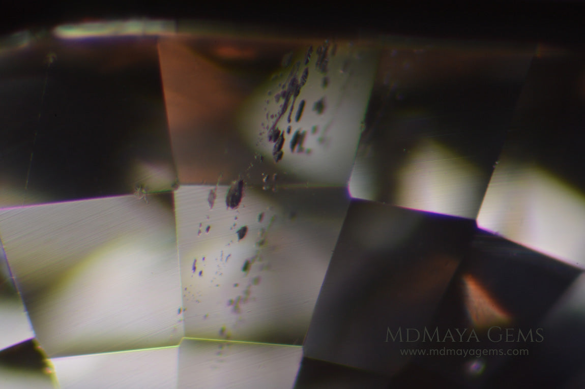 Inclusions in Unheated white sapphire 1.00 ct. Round cut.