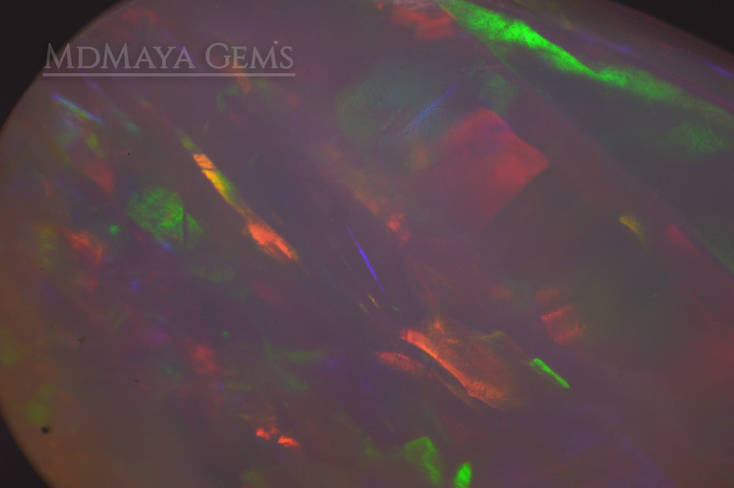 Elegant light crystal Welo opal 2.77 ct with firework pattern under microscope