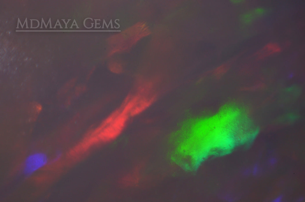 Elegant light crystal Welo opal 2.77 ct with firework pattern under microscope