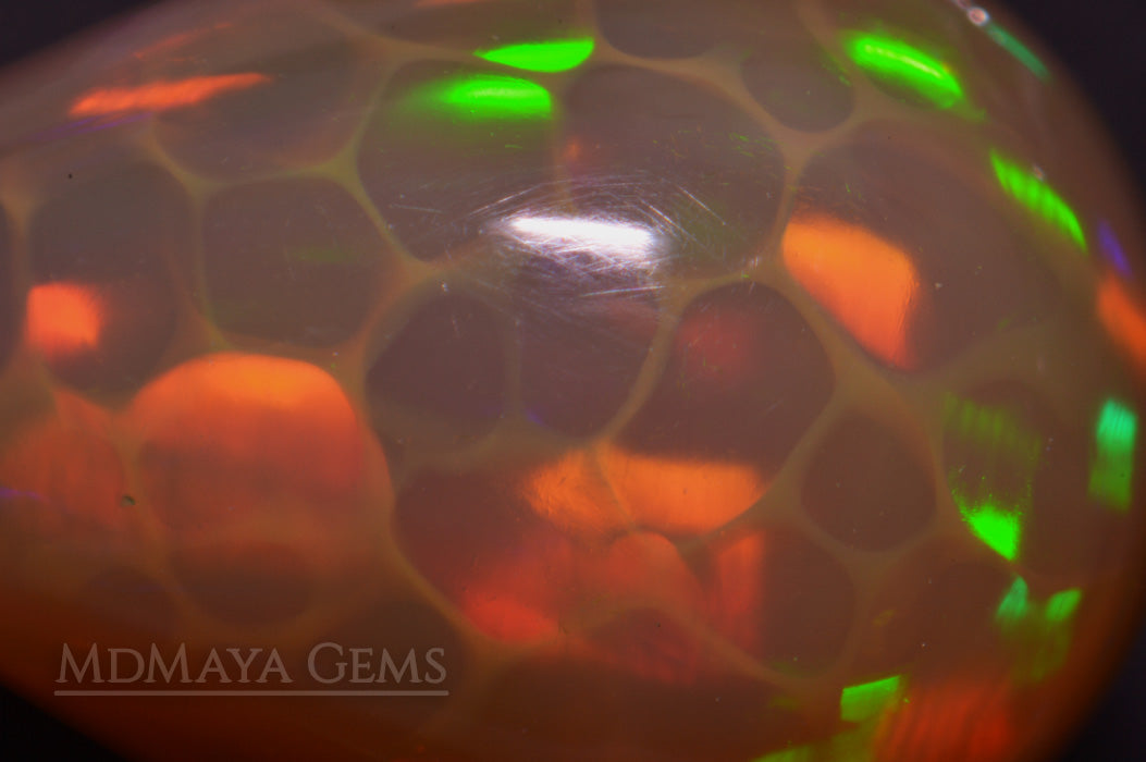Super HoneyComb Opal from Ethiopia 4.47 ct. Pear Cabochon Cut under microscope