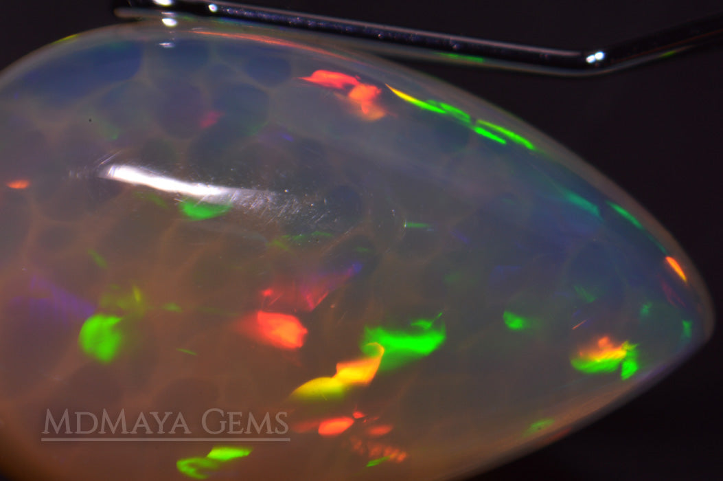 Welo Opal Gemstone 4.82 ct. Pear Cabochon Cut with honeycomb pattern under microscope