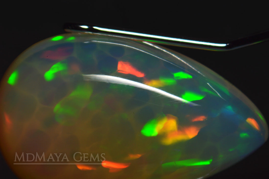 Welo Opal Gemstone 4.82 ct. Pear Cabochon Cut with honeycomb pattern under microscope