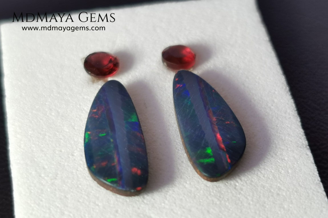 Opal Doublets and Red Garnets. This set is composed by a pair of bright Australian Opal doublet and two vivid Garnets. The perfect combination for your bespoke jewelry. 