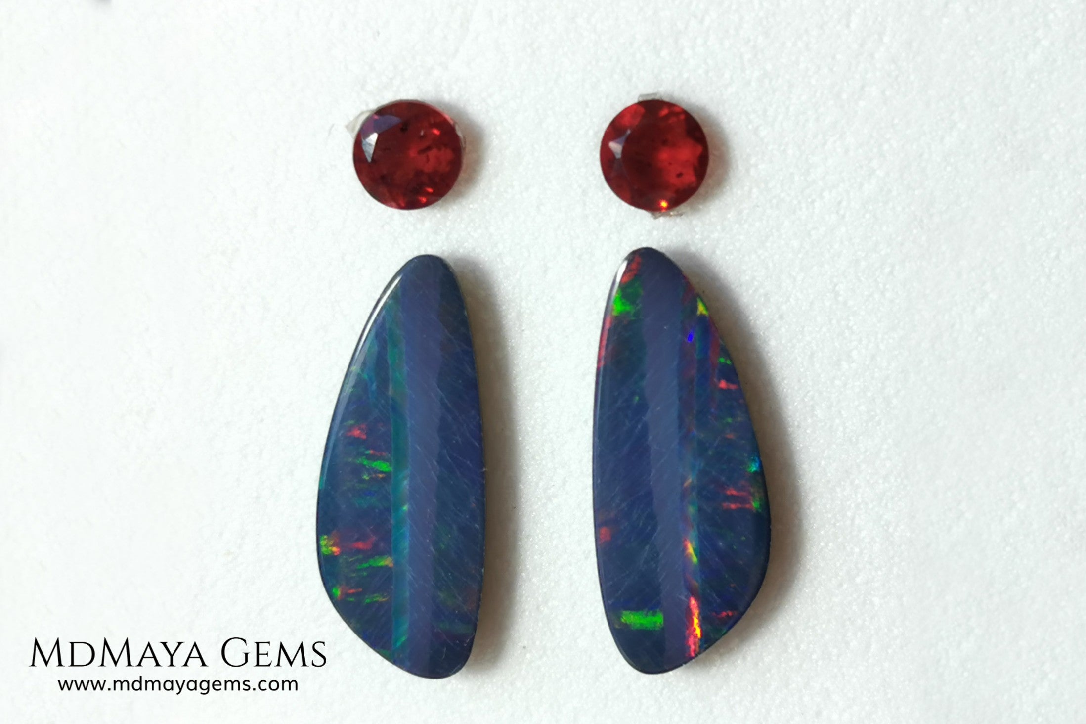Opal Doublets and Red Garnets. This set is composed by a pair of bright Australian Opal doublet and two vivid Garnets. The perfect combination for your bespoke jewelry. 
