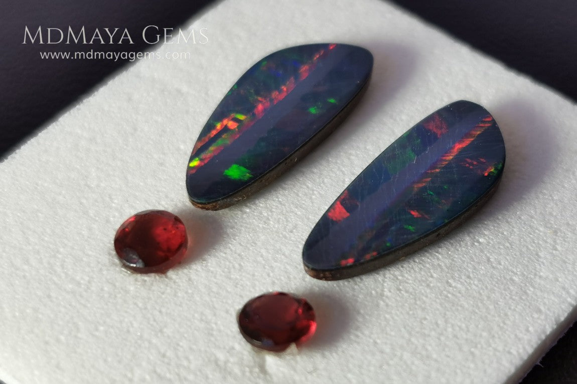 Opal Doublets and Red Garnets. This set is composed by a pair of bright Australian Opal doublet and two vivid Garnets. The perfect combination for your bespoke jewelry. 