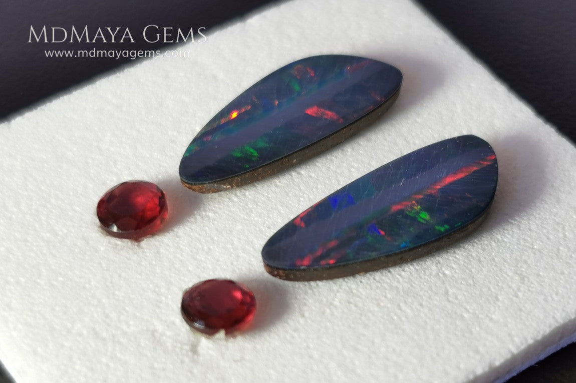 Opal Doublets and Red Garnets. This set is composed by a pair of bright Australian Opal doublet and two vivid Garnets. The perfect combination for your bespoke jewelry. 