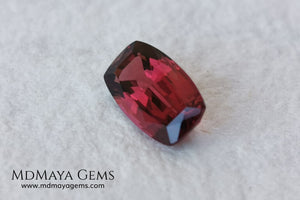 Rhodolite, 2.01 ct, cushion cut. This affordable gem has an excellent cut, very well proportioned, which makes purplish red glitters come out of its facets at the slightest movement. It has a very good measurement, since although it is a two-carat gemstone, it would look amazing in a ring or pendant.