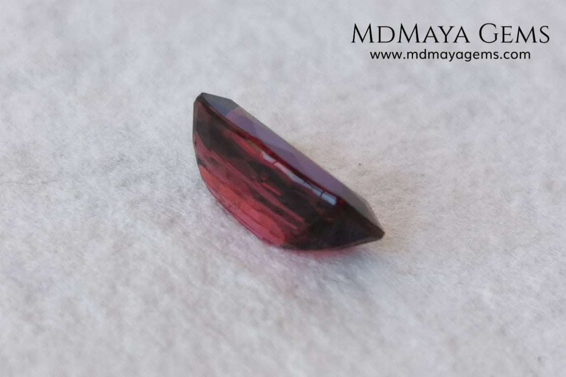 Rhodolite, 2.01 ct, cushion cut. This affordable gem has an excellent cut, very well proportioned, which makes purplish red glitters come out of its facets at the slightest movement. It has a very good measurement, since although it is a two-carat gemstone, it would look amazing in a ring or pendant.