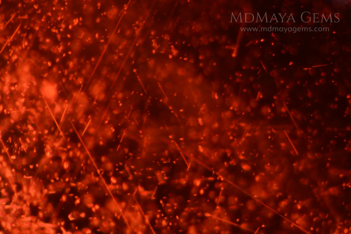 Inclusions in red rhodolite garnet 5.09 ct oval cut