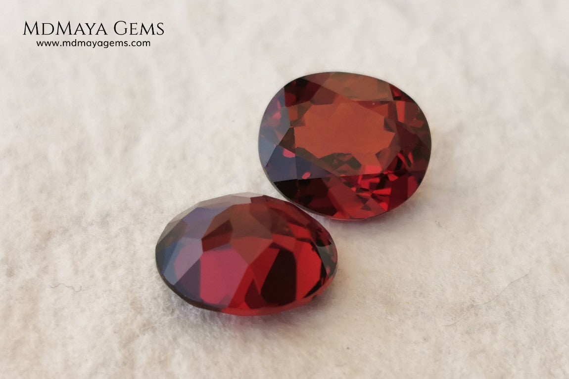 Dark Red Rhodolite Pair, 5.24 ct, oval cut. This beautiful pair of rhodolites shows a dark red color, although it is full of life and sparkles. It has a very good size and they will look incredibly beautiful on some earrings or on a pair of cufflinks.