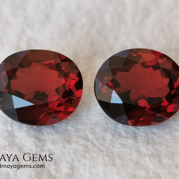 Dark Red Rhodolite Pair, 5.24 ct, oval cut. This beautiful pair of rhodolites shows a dark red color, although it is full of life and sparkles. It has a very good size and they will look incredibly beautiful on some earrings or on a pair of cufflinks.