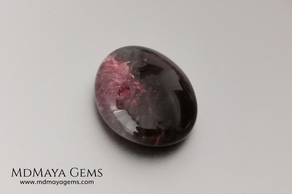 Large tourmaline rubellite, 16.08 ct, oval cabochon cut. This beautiful natural gem features two shades of color, one darker than the other. Although it has inclusions, it will be beautiful once mounted on any piece of jewelry you can imagine. And the best its price. $15 per carat.