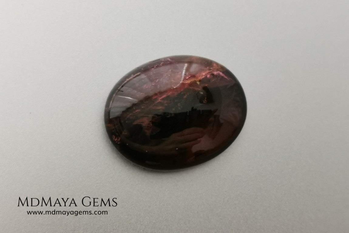 Large tourmaline rubellite, 16.08 ct, oval cabochon cut. This beautiful natural gem features two shades of color, one darker than the other. Although it has inclusions, it will be beautiful once mounted on any piece of jewelry you can imagine. And the best its price. $15 per carat.