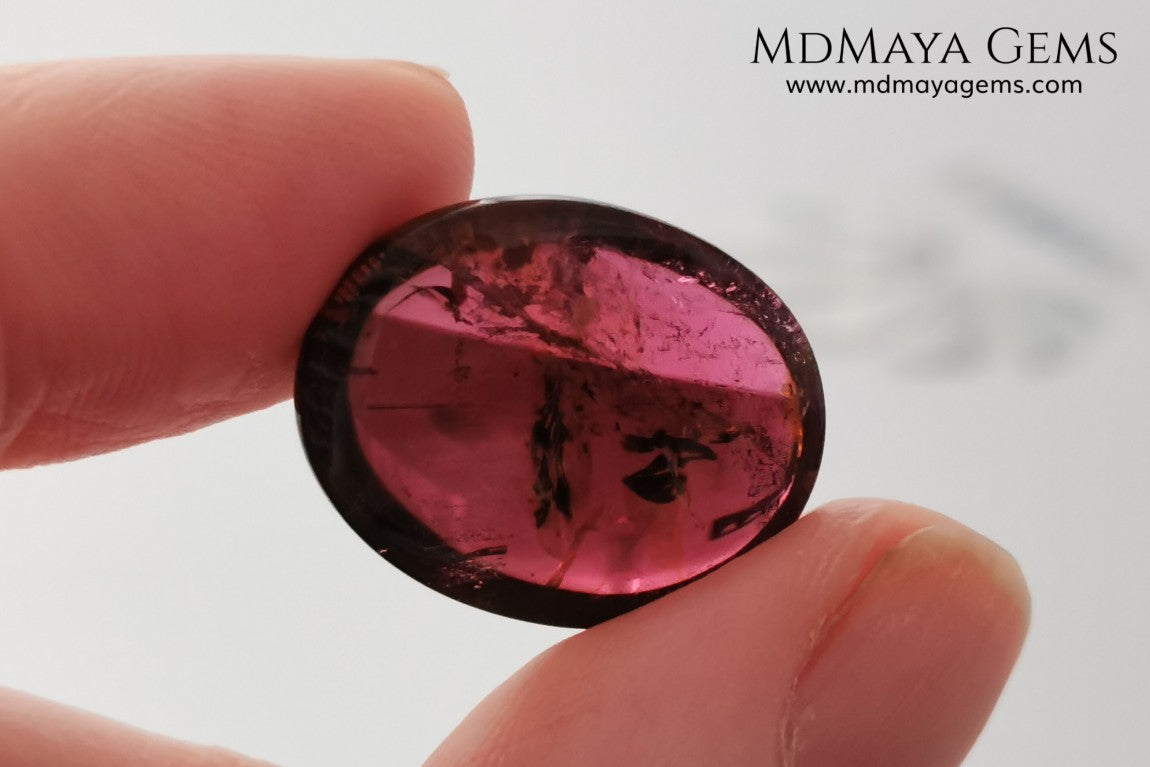 Large tourmaline rubellite, 16.08 ct, oval cabochon cut. This beautiful natural gem features two shades of color, one darker than the other. Although it has inclusions, it will be beautiful once mounted on any piece of jewelry you can imagine. And the best its price. $15 per carat.