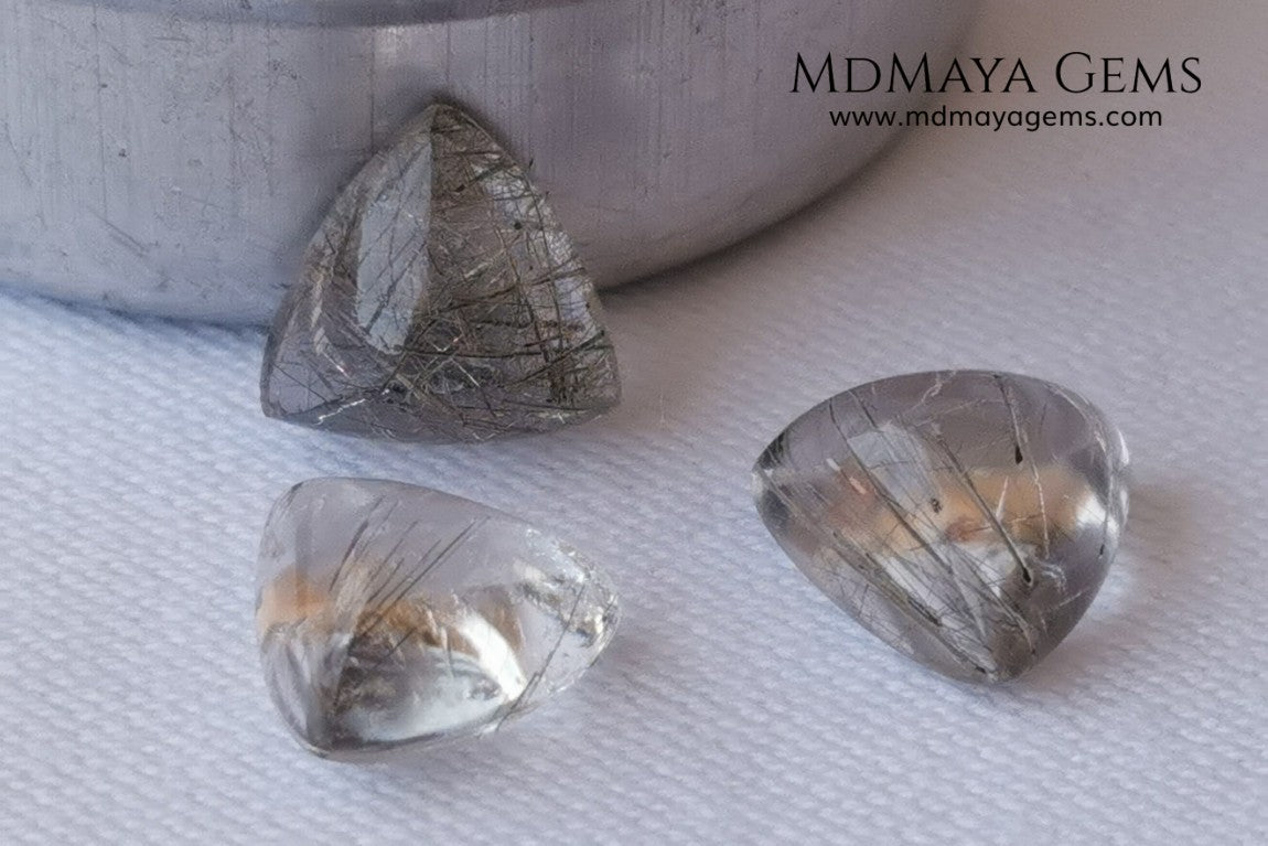 Metallic Rutilated Quartz 9.82 ct set. Outstanding set of rutilated quartz with beautiful inclusions. Perfect for your custom jewelry.  2.73 ct .. 9.93 * 9.83 * 4.73 mm 3.94 ct .. 10.23 * 10.35 * 5.80 mm 3.15 ct .. 9.93 * 9.72 * 5.39 mm