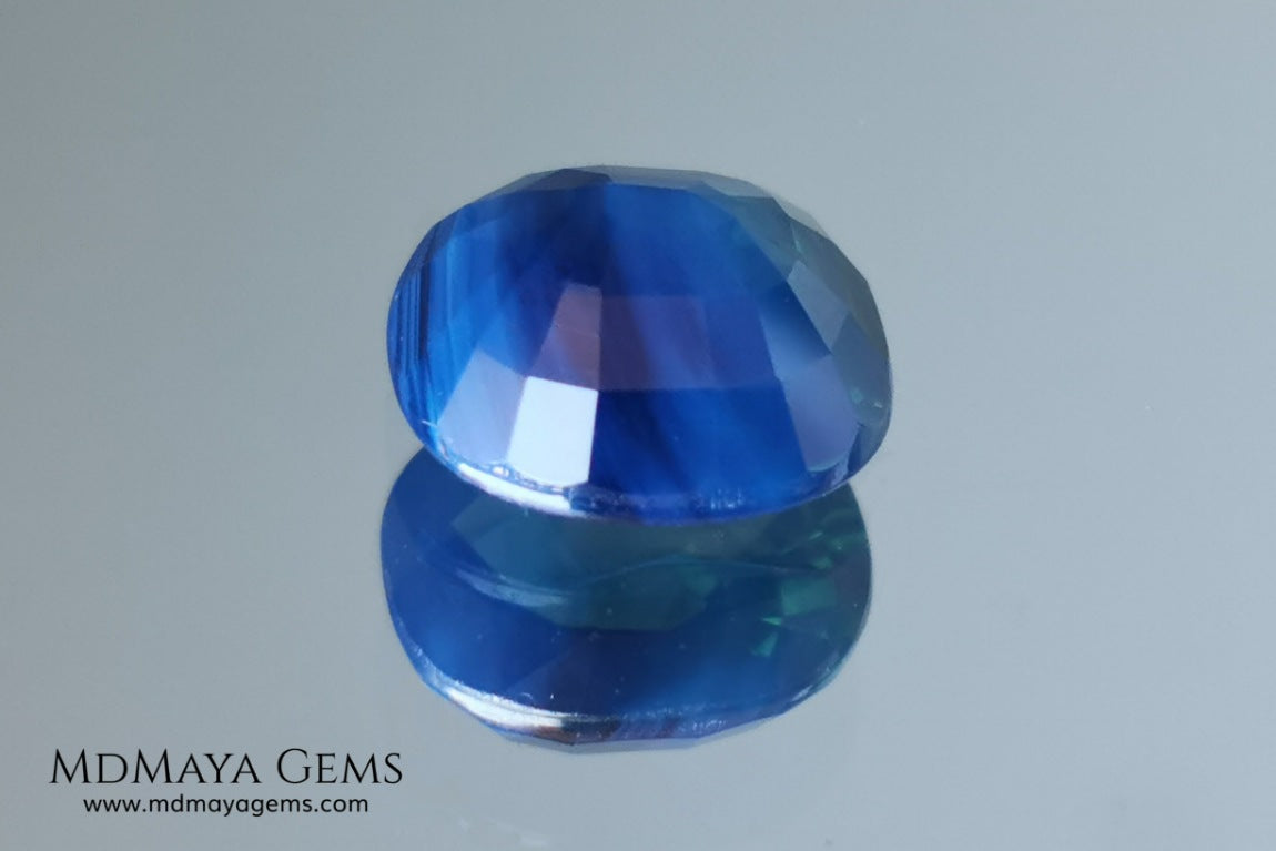 Untreated greenish blue Sapphire 3.61 ct. Cushion cut.  natural untreated blue sapphire has a large green component inside, under natural light you can see a dull and translucent blue sapphire, although under incandescent light everything changes, this sapphire shines from all sides and a bright green color is seen throughout the interior. It is a gem only for the very daring, with an extra: its price (certificate included).