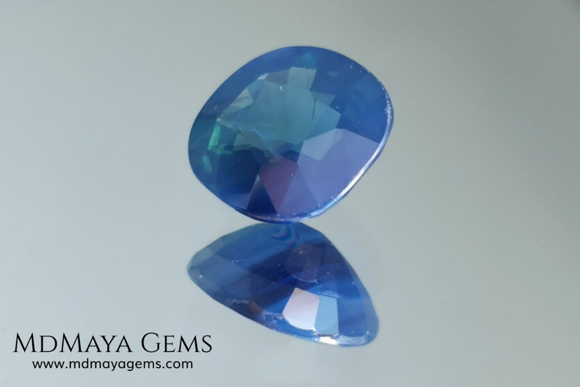 Untreated greenish blue Sapphire 3.61 ct. Cushion cut.  natural untreated blue sapphire has a large green component inside, under natural light you can see a dull and translucent blue sapphire, although under incandescent light everything changes, this sapphire shines from all sides and a bright green color is seen throughout the interior. It is a gem only for the very daring, with an extra: its price (certificate included).